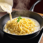 Tossing pasta with ricotta and lemon sauce